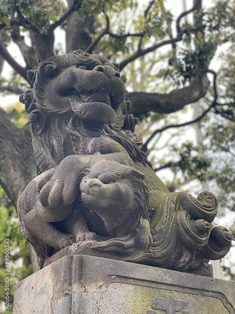 Guardian lion at the shrine of Japan, Otori Shrine, Tokyo, stone structure Guardian lion at the shrine of Japan, Otori Shrine, Tokyo, stone structure