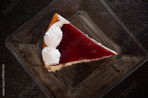 A slice of cheesecake in a glass plate