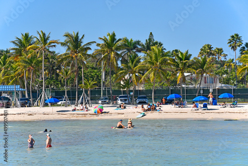 Warm sunny day with palm trees swaying at Higgs Memorial Beach Park in Key West, Florida