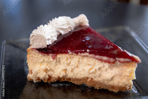 A slice of cheesecake in a glass plate