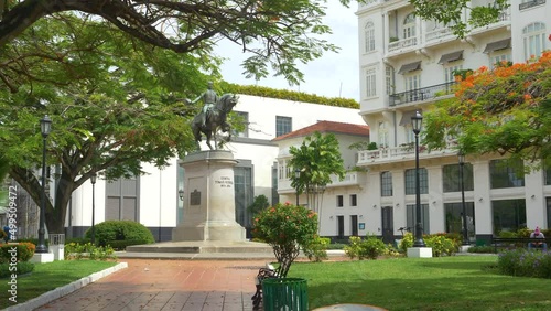 Historic monument stands in the middle of a lush green park in downtown Panama City. Tomas Herrera statue is surrounded by lush greenery in historic Casco Viejo neighborhood. Tourist attraction. photo