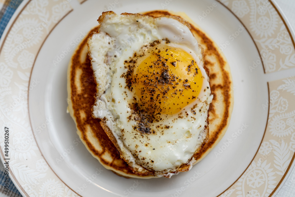 American breakfast. Fried egg over a pancake. American breakfast. Fried egg over a pancake.