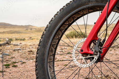 front wheel of a fat mountain bike with a hydraulic disk brake at foothills of Colorado, early spring scenery