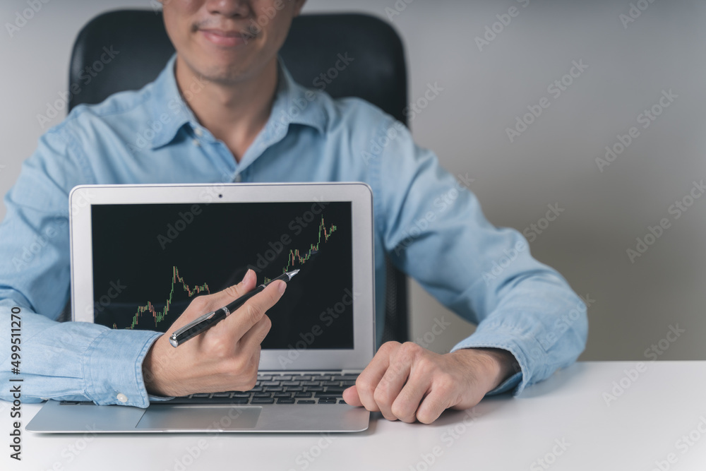 Asian businessman, trader, investor pointing Bitcoin cryptocurrency, stock market technical price candle chart for trading, investing stock, Bitcoin cryptocurrency on online platform. Trading concept. Asian businessman, trader, investor pointing Bitcoin cryptocurrency, stock market technical price candle chart for trading, investing stock, Bitcoin cryptocurrency on online platform. Trading concept.