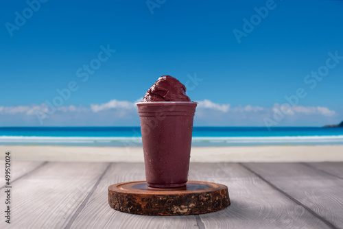 Ice Cream acai Cup on background tropical beach photo