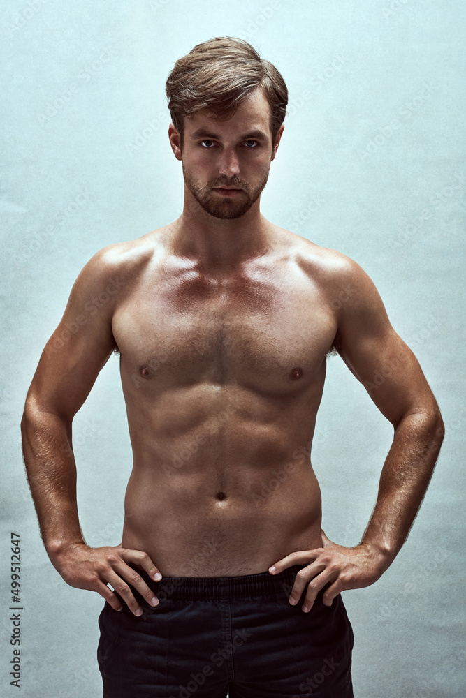Hes the whole package. Shot of a handsome bare-chested young man posing in the studio.