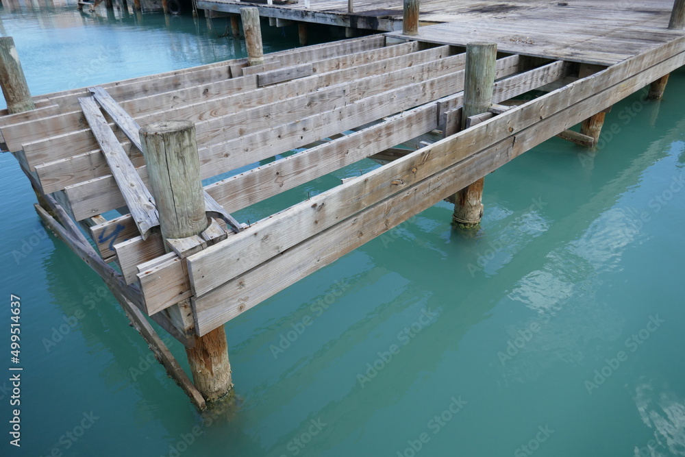 Unfinished wooden boat dock over ocean water