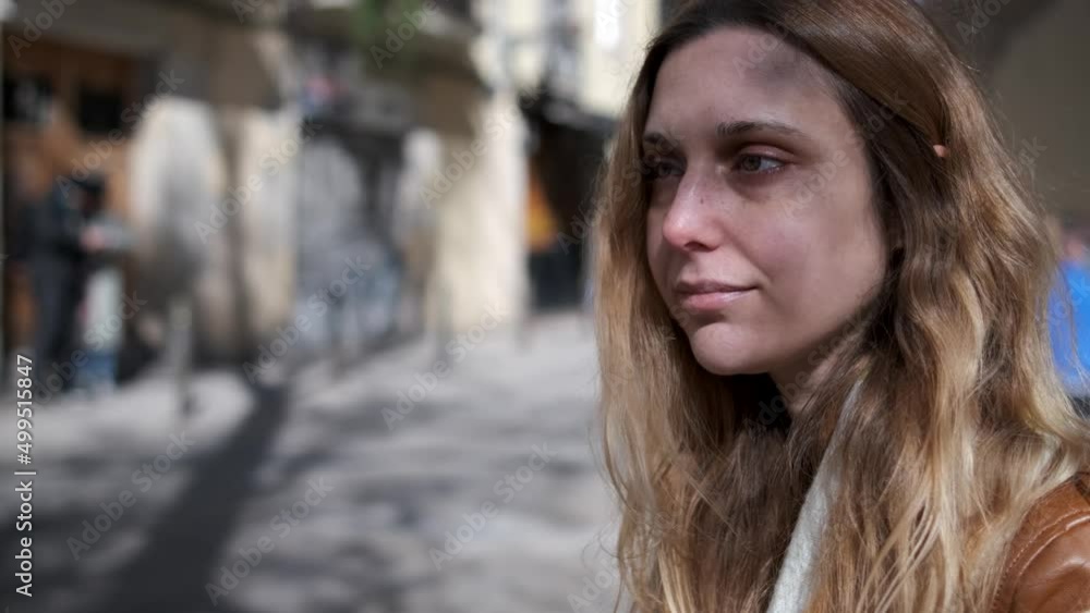 young blonde woman looking to one side in the street. young blonde woman looking to one side in the street.