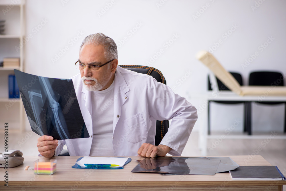 Old male doctor radiologist working in the clinic Old male doctor radiologist working in the clinic