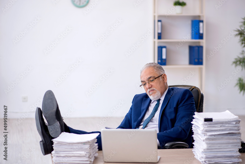 Old male employee and too much work in the office Old male employee and too much work in the office