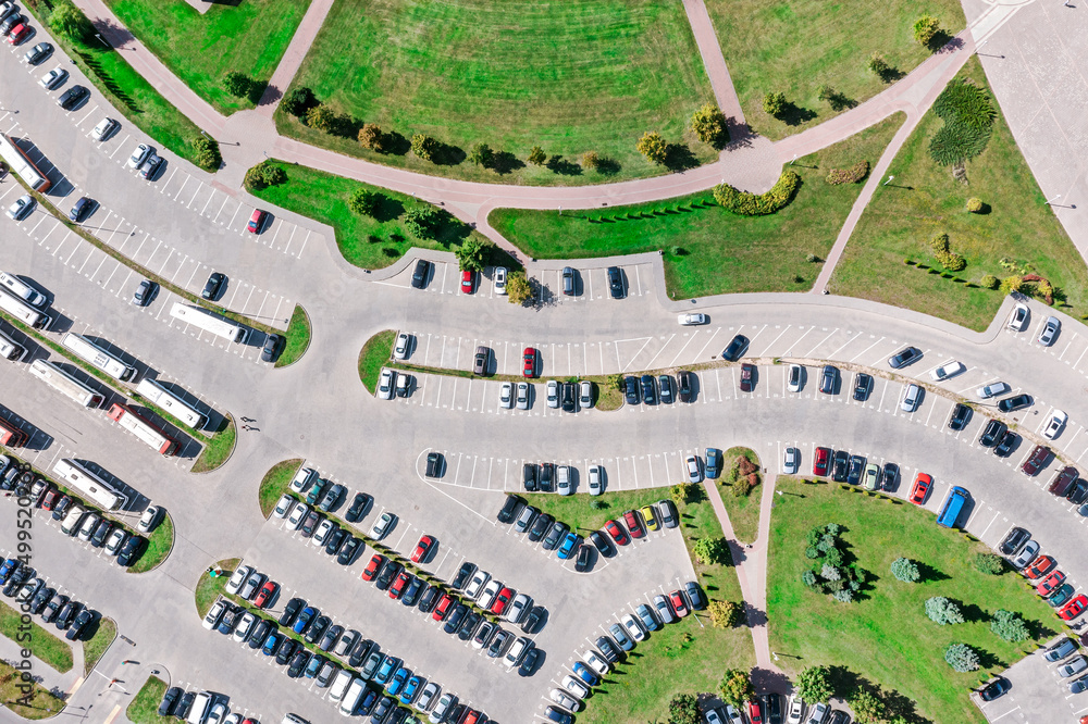 urban public parking lot viewed from above in sunny summer day. aerial overhead view.