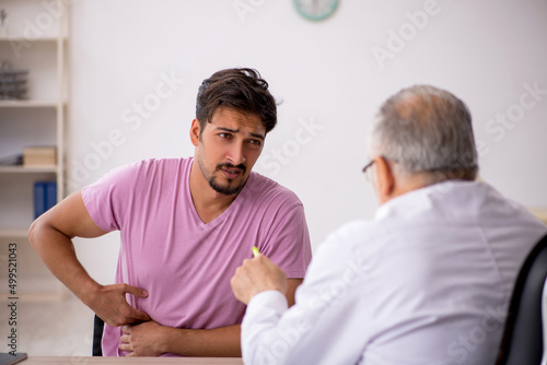 Young male patient visiting old male doctor © Elnur