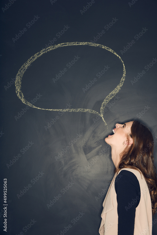 Dont hold back. Studio shot of a young woman posing with a chalk illustration of a speech bubble against a dark background. Dont hold back. Studio shot of a young woman posing with a chalk illustration of a speech bubble against a dark background.