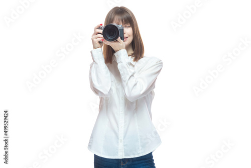 Portrait of a young woman in a white shirt taking pictures with a camera. The concept of a successful photographer, wedding photographer, photo for documents. Isolated on white background. © satyrenko