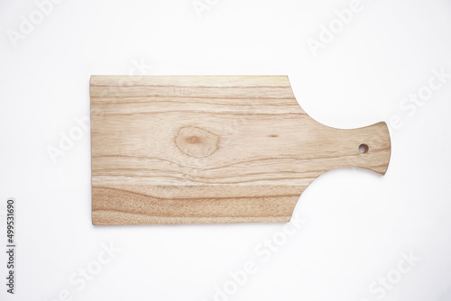 Food preparation tool and kitchen utensils concept with close-up on rectangular wood chopping board with round corners isolated on white background at an angle perspective with clipping path cutout