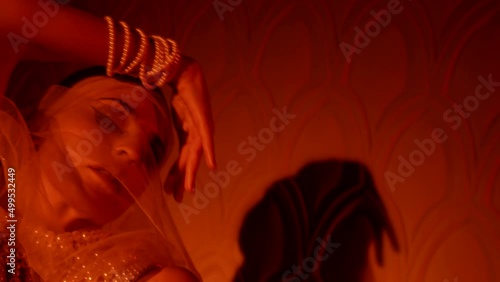 alluring arabian concubine is dancing in harem in night, seduction and temptation, closeup of face photo