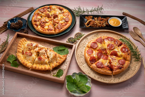 Tasty pepperoni pizza and Mushroom and Sausage Pizza on wooden background. Top view of hot pepperoni pizza.