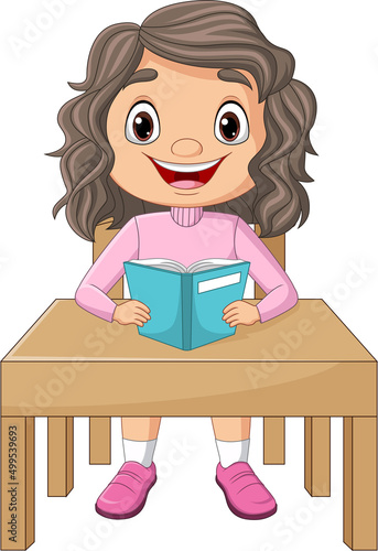 Cartoon little girl reading a book on the desk