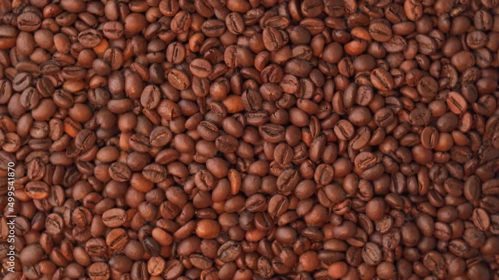 Brown freshly roasted coffee beans rotate, top view Brown freshly roasted coffee beans rotate, top view