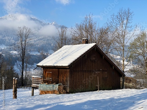 Indigenous alpine huts and wooden cattle stables on Swiss pastures covered with fresh white snow cover, Nesslau - Obertoggenburg, Switzerland (Schweiz) © Mario