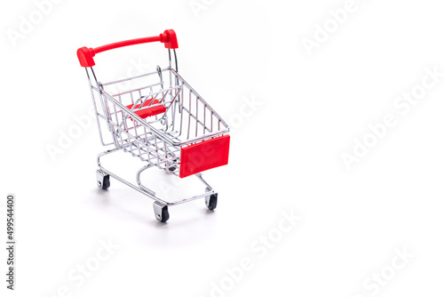 Savings and Sale Ideas. One Empty Trolley Shopping or Sale Cart Placed Over Seamless Solid White Background With Space for Text
