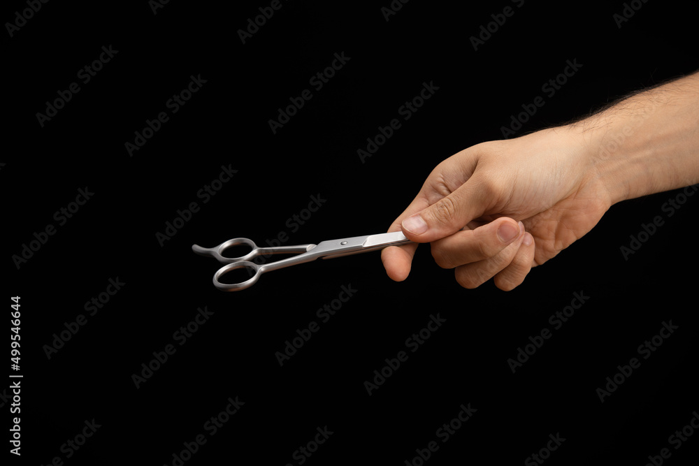 hand of a man handing and giving a scissors hand of a man handing and giving a scissors