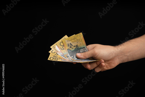 hand of a man giving australian dollars
