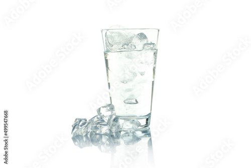 Glass with water and ice isolated on white background