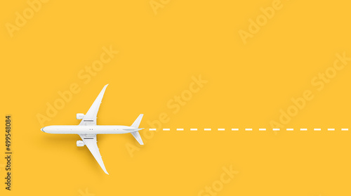 Toy plane on yellow background top view