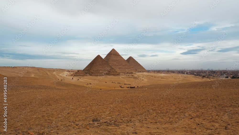 Daily life in Giza complex or necropolis with main pyramids (Great of Giza, of Khafre, of Menkaure), subsidiary ones, remains. Timelapse. Tourists see landmarks of ancient Egypt on horseback, camels Daily life in Giza complex or necropolis with main pyramids (Great of Giza, of Khafre, of Menkaure), subsidiary ones, remains. Timelapse. Tourists see landmarks of ancient Egypt on horseback, camels