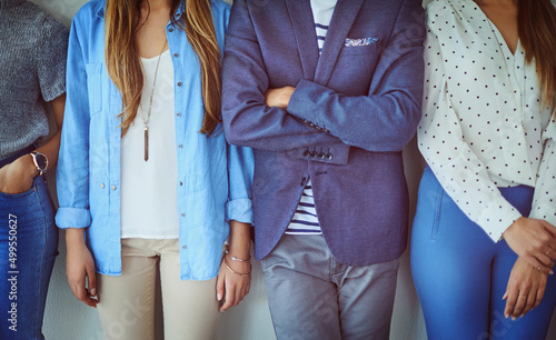 Everyones waiting for their name to be called. Studio shot of a group of unrecognizable businesspeople standing in line against a grey background.