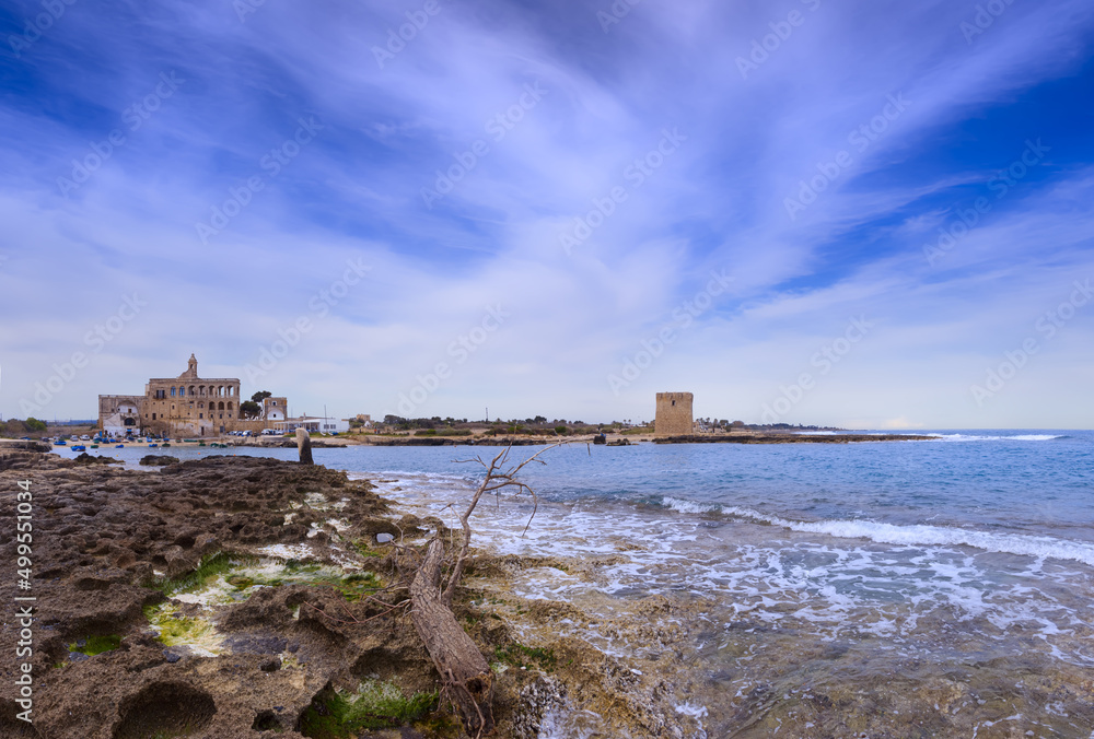 Apulia coast: the beach of San Vito, with a view on the imposing Benedictine abbey dedicated to the patron saint, offers an appealing view, not far away from Polignano a Mare in southern Italy.