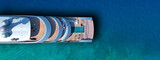 Aerial drone top view ultra wide photo of large yacht anchored in tropical exotic paradise with turquoise open sea