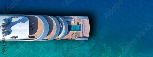 Aerial drone top view ultra wide photo of large yacht anchored in tropical exotic paradise with turquoise open sea photo