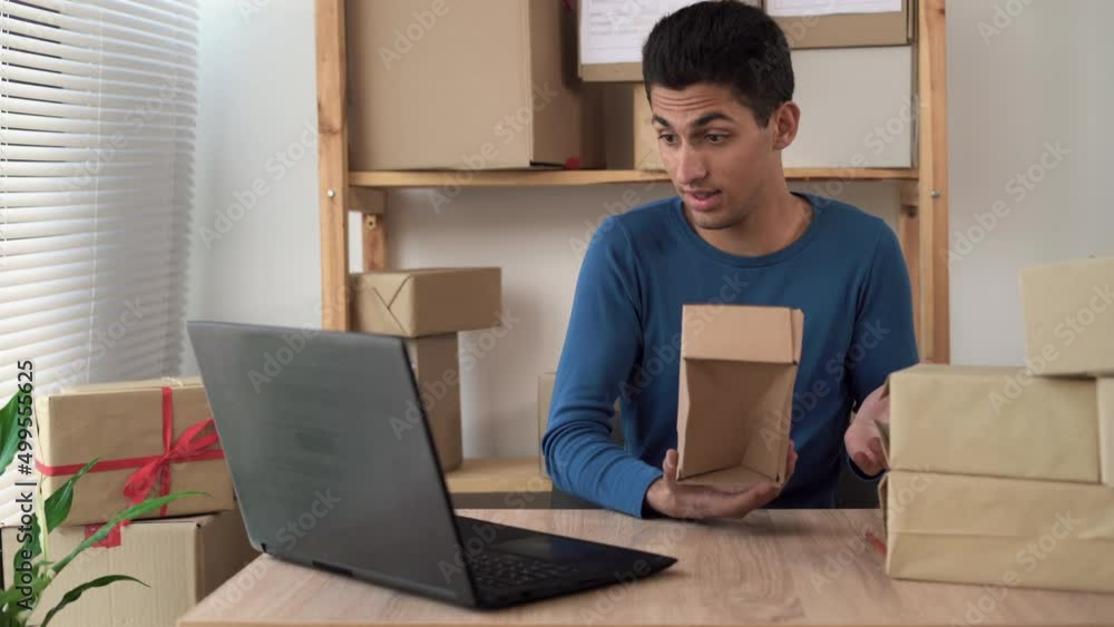 small business, owner of a home warehouse shows a crumpled and damaged box, order delivery, SME, online ordering small business, owner of a home warehouse shows a crumpled and damaged box, order delivery, SME, online ordering