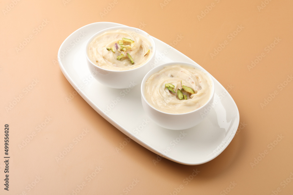 Shrikhand is an Indian sweet dish made of strained curd,garnished with