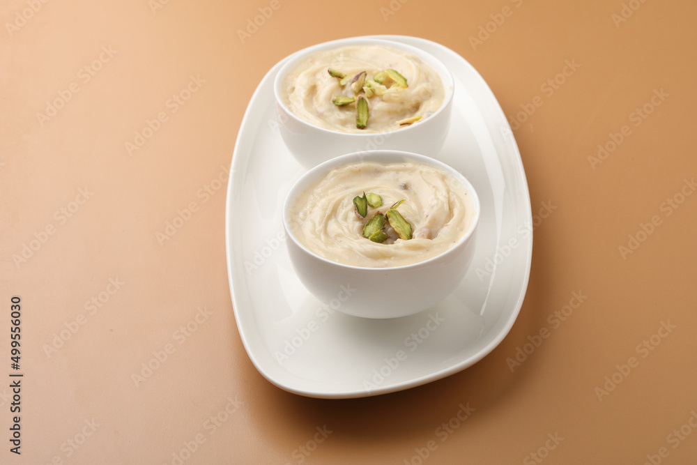 Shrikhand is an Indian sweet dish made of strained curd,garnished with