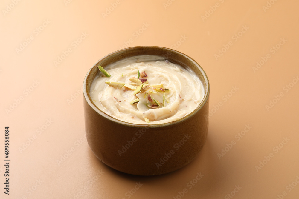 Shrikhand is an Indian sweet dish made of strained curd,garnished with