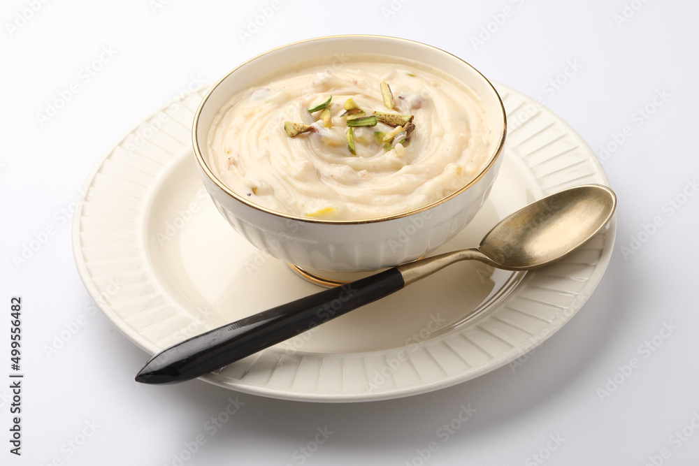 Shrikhand is an Indian sweet dish made of strained curd,garnished with