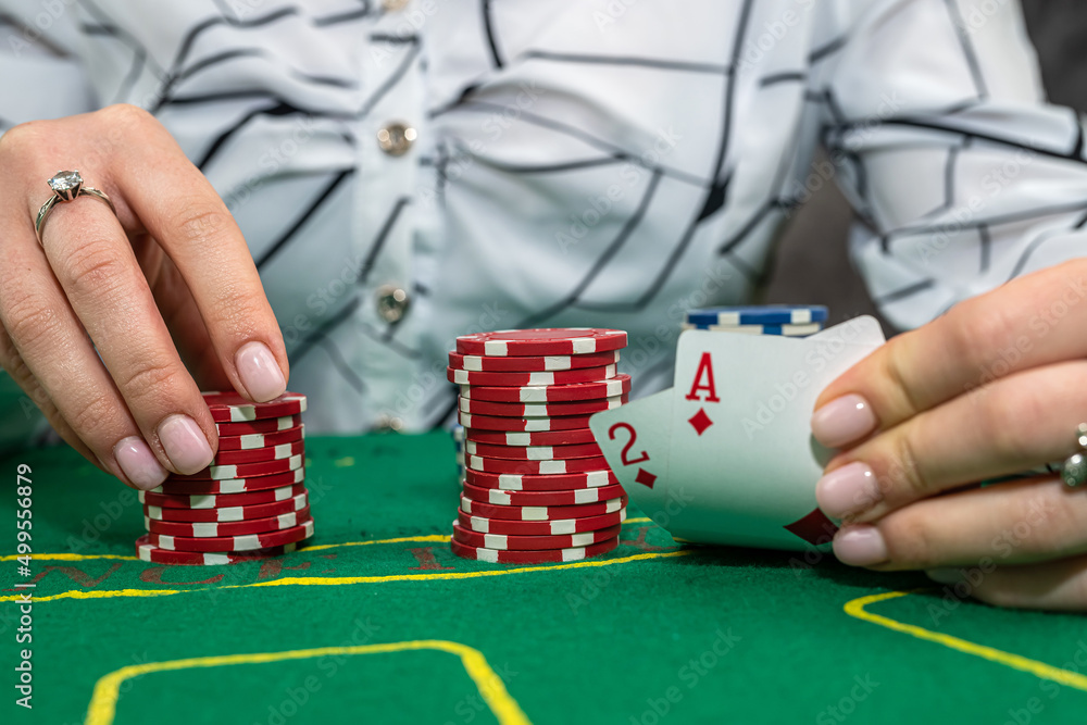young woman in suit playing poker, gambling concept young woman in suit playing poker, gambling concept