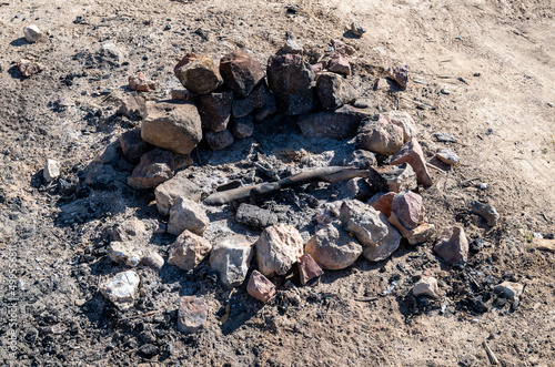 stones piled around a fire pit at an outdoor picnic.