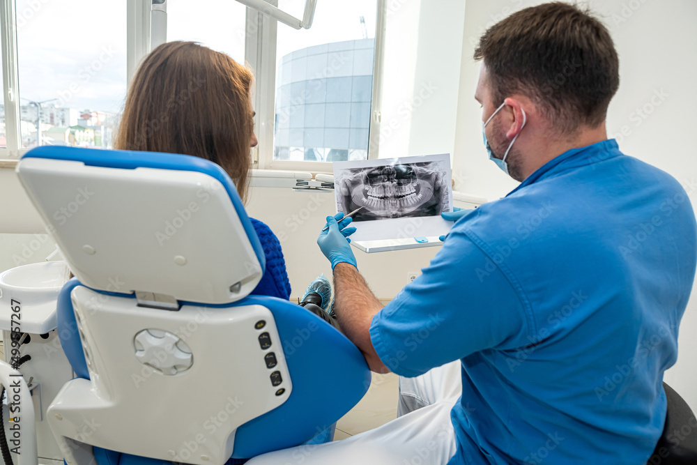 dentistry, a dentist who knows his business takes pictures for a patient with diseased teeth. dentistry, a dentist who knows his business takes pictures for a patient with diseased teeth.