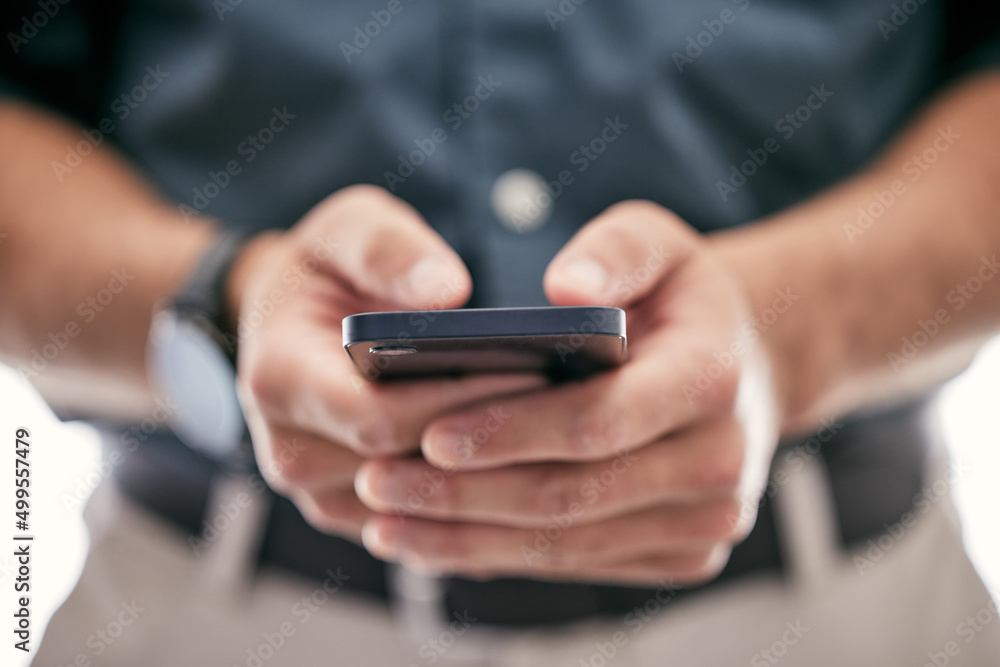 Putting the pieces together. Shot of an unrecognizable businessman using a smartphone in a modern office. Putting the pieces together. Shot of an unrecognizable businessman using a smartphone in a modern office.