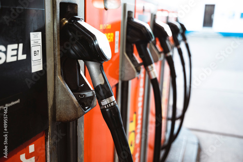 gas pump nozzles at the gas station photo