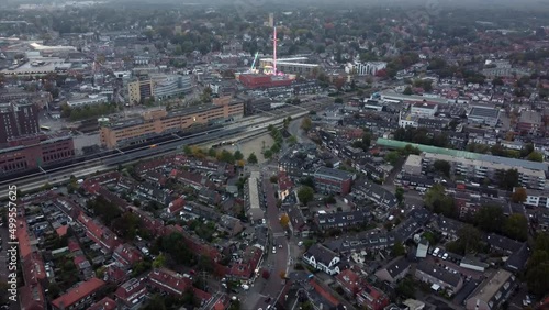 Aerial view arriving at fair showing several funfair attractions and wave swinger is amusement ride that is a variation on the carousel in which the seats are suspended from the rotating summit 4k