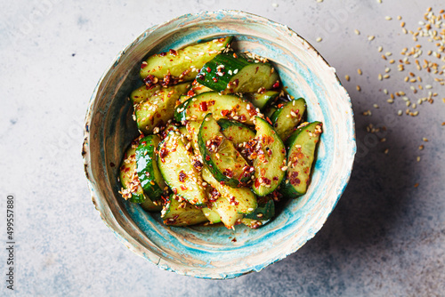 Chinese smashed cucumber salad with chili peppers and sesame seeds, copy space.