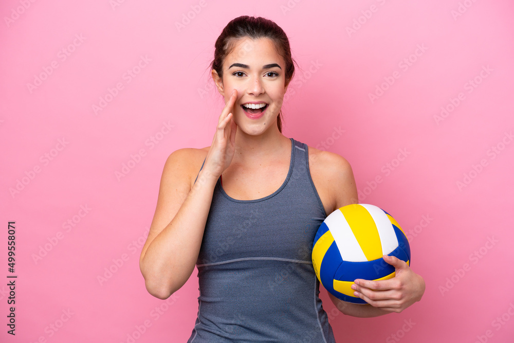 Young Brazilian woman playing volleyball isolated on pink background shouting with mouth wide open