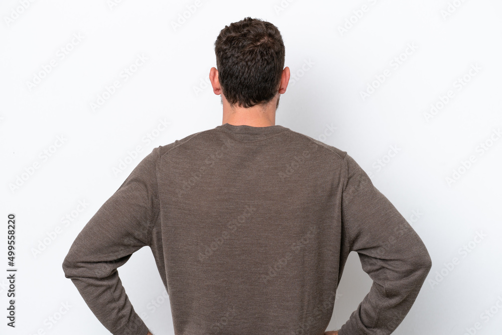 Young Brazilian man isolated on white background in back position Young Brazilian man isolated on white background in back position