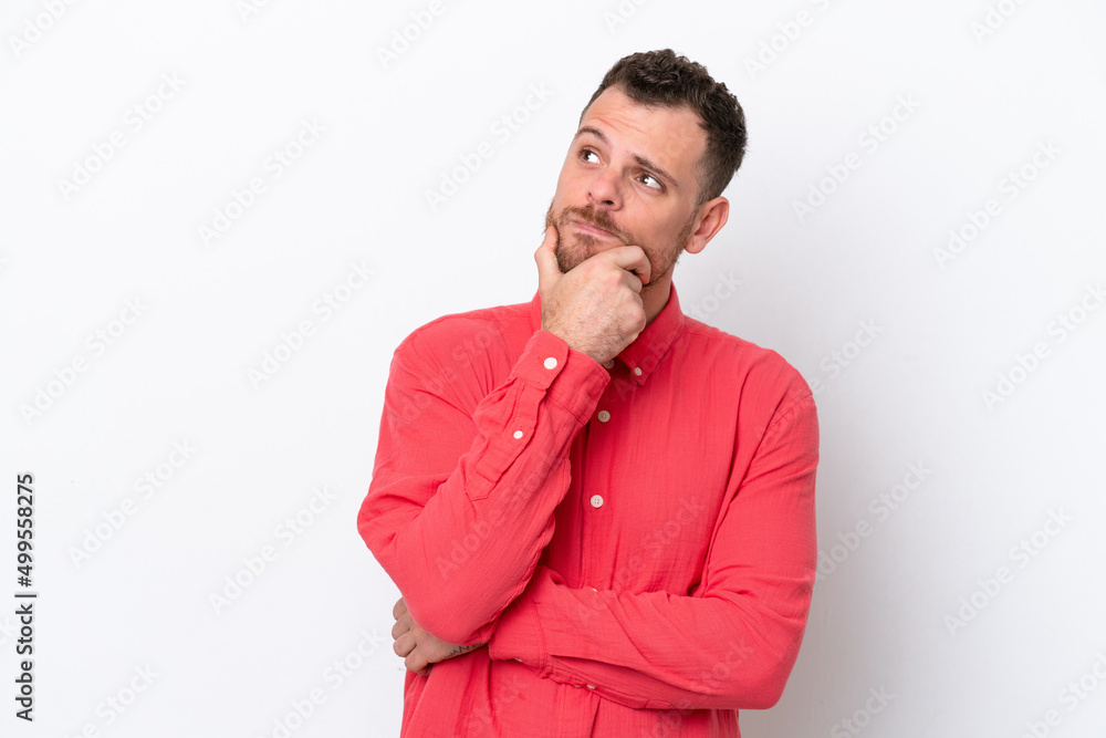 Young Brazilian man isolated on white background having doubts Young Brazilian man isolated on white background having doubts