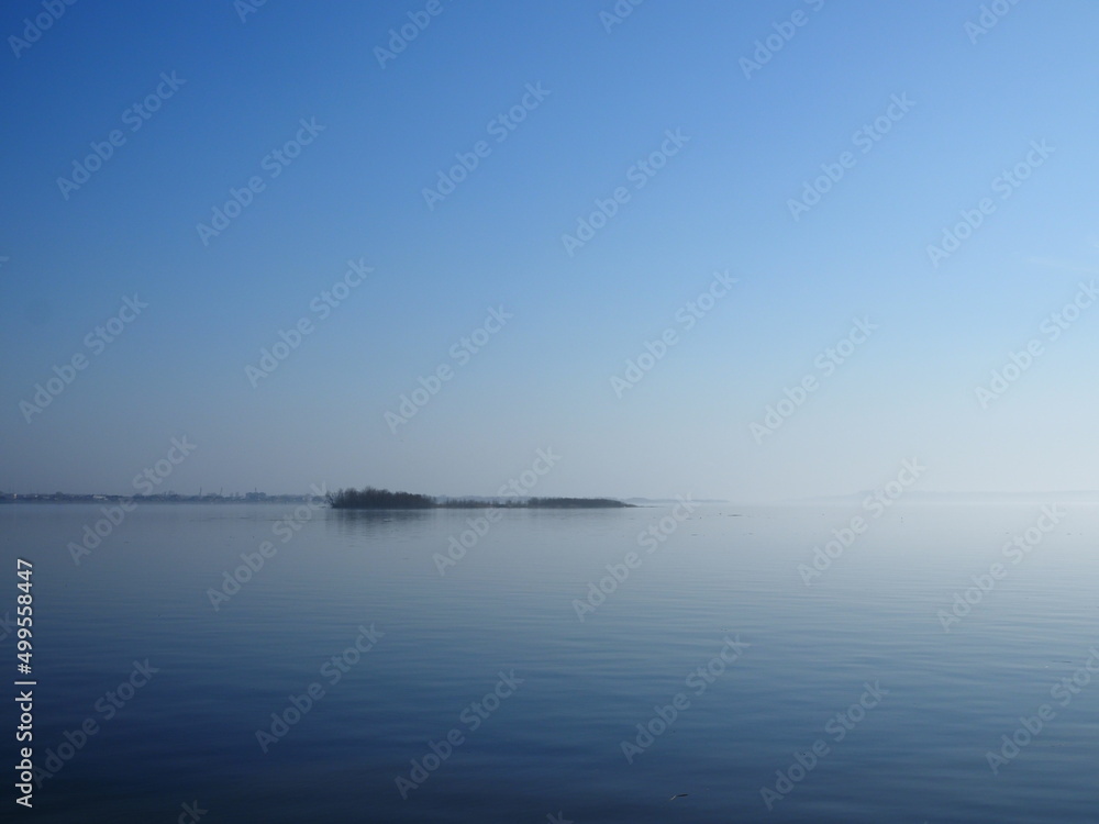 island in the fog on the Volga in spring